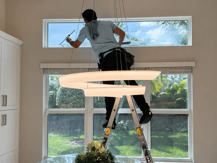 Crystal Bear technician cleaning interior windows inside a home